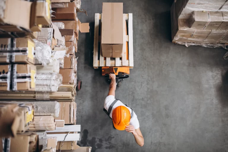 young-man-working-warehouse-with-boxes_1303-16617